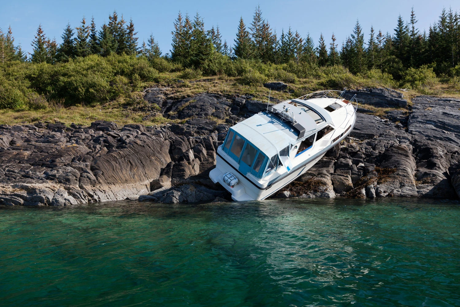 Accident at sea; photo of recreational boat on dry land after collision with rocks