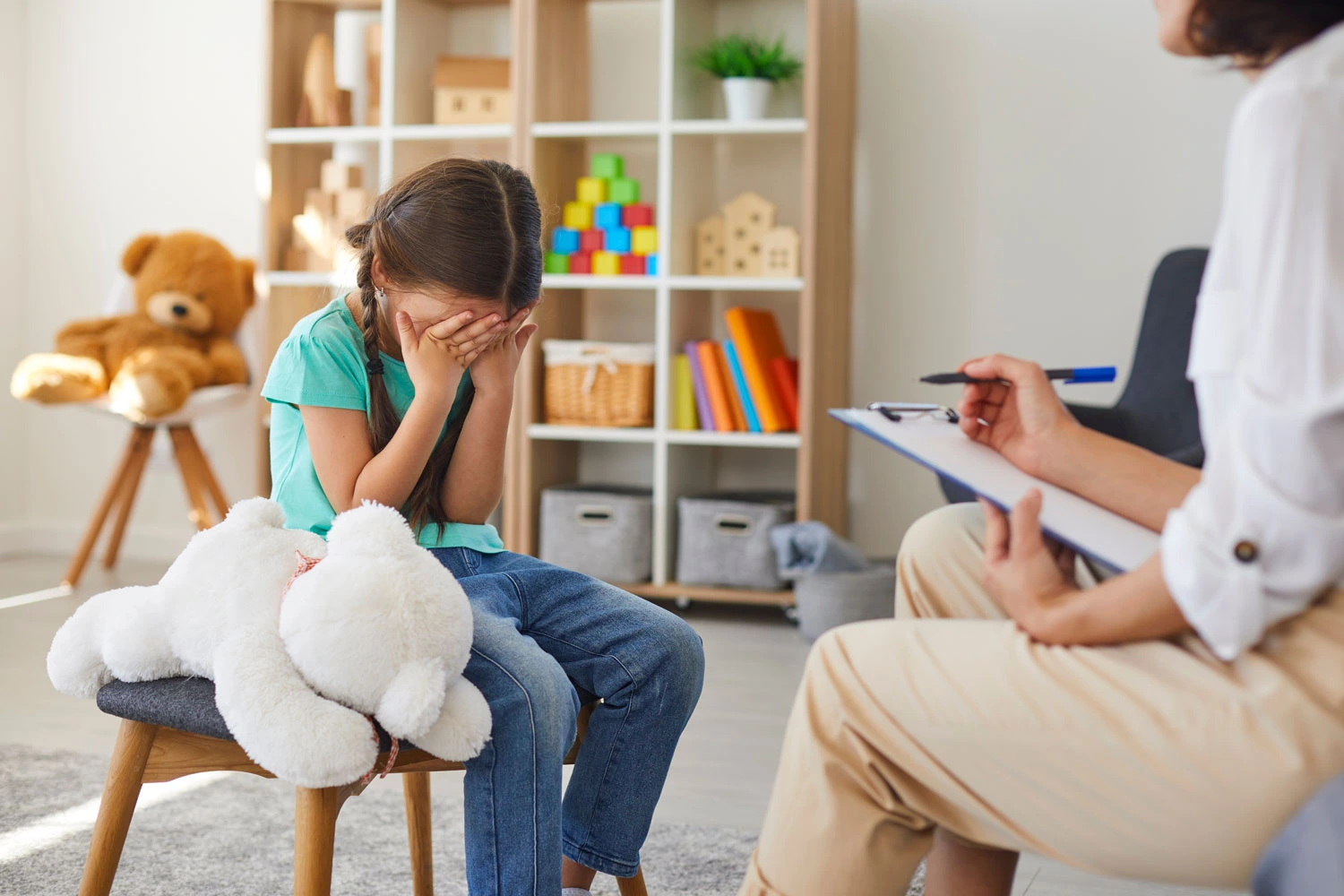 Bullied little schoolgirl crying in psychologist's office unable to control emotions