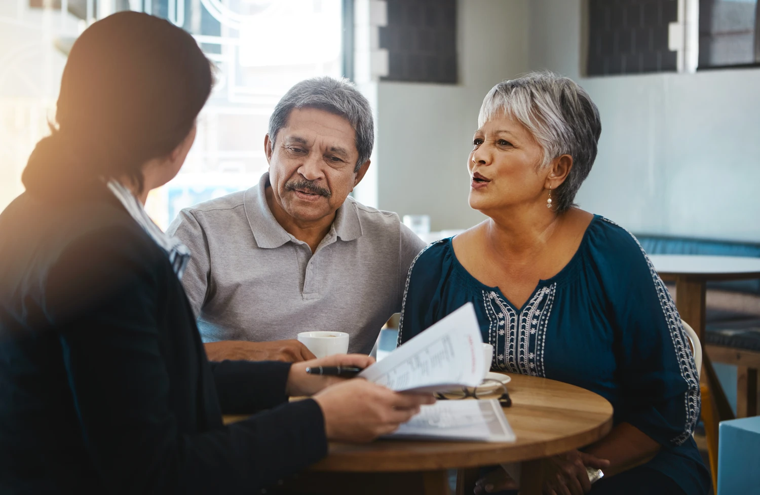 Senior couple, talking and lawyer with documents for financial advice, retirement plan and will at home.